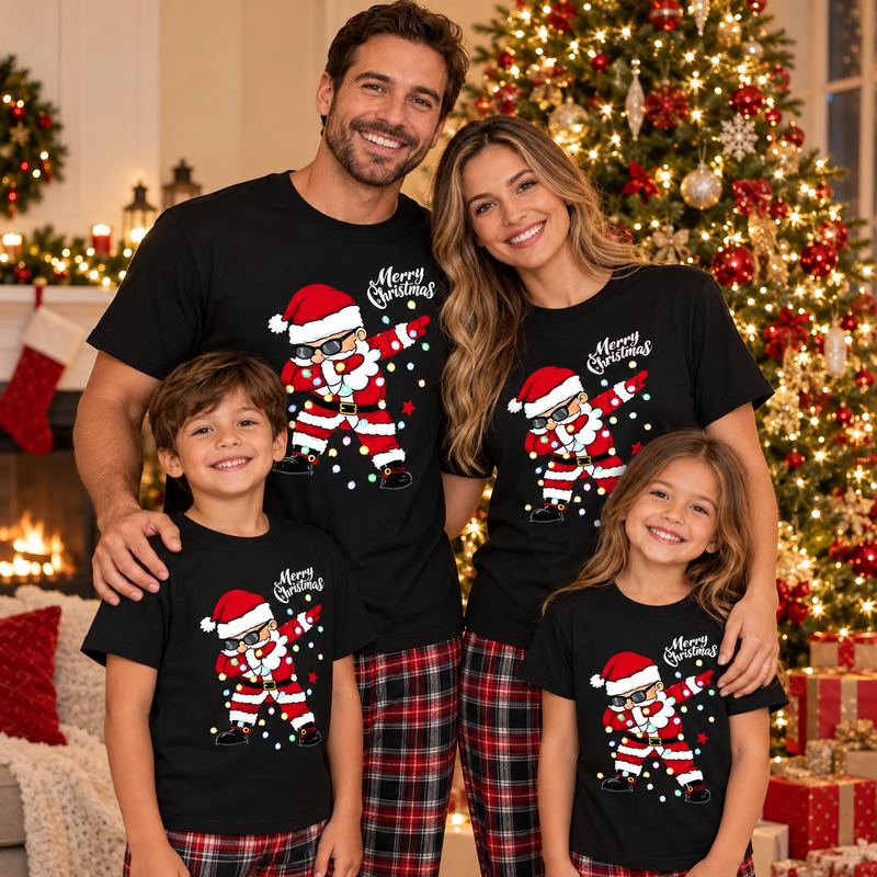 American family of four in matching black dabbing Santa Christmas T-shirts smiling in front of a decorated Christmas tree